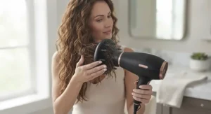 Demonstration of using a hair dryer on a low setting to maintain moisture in wavy hair.