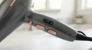 Ergonomic handle and adjustable heat settings panel on a modern root-lifting hair dryer.