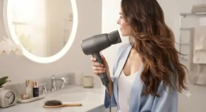 An ergonomic fast-drying hair dryer for long hair being comfortably held during a morning routine.
